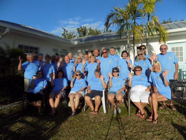 A group of 24 guest with matching blue t-shirts.