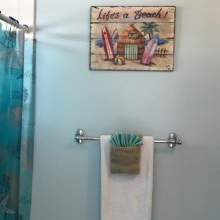 Light blue bathroom, surfboard image
